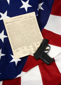 Declaration of Independence with Hand Gun on American Flag