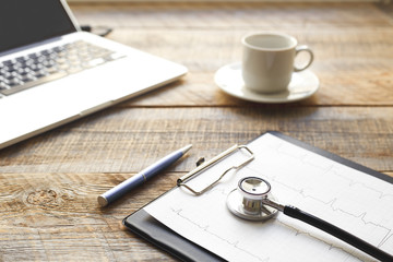 doctor workplace with a stethoscope at wooden table