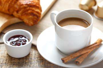 Breakfast with coffee and croissants on wooden table