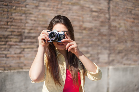Young woman  taking pictures outdoor