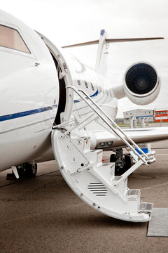 Ladder with open door in business jet airplane