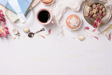 Fototapeta na wymiar Pastries and coffee, white background. High angle view, copy space.
