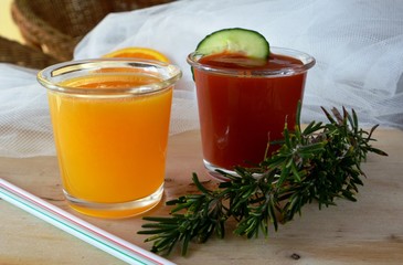 Two glasses of fresh smoothie with orange and tomato