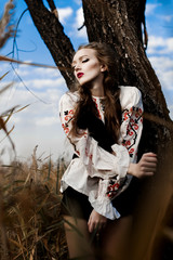 Young girl on the summer field  in national Belarus clothes, fas