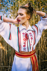 Young girl on the summer field  in national Belarus clothes, fas