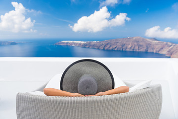 Travel vacation woman relaxing enjoying Santorini looking at famous view of Caldera. Young lady...