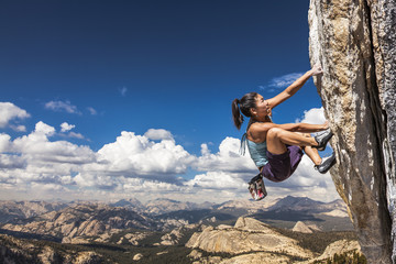 Rock climber clinging to a cliff.