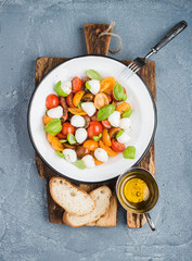 Italian Caprese salad with cherry tomatoes, small mozzarella and fresh basil