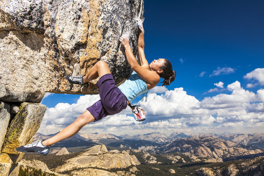 Rock climber clinging to a cliff.