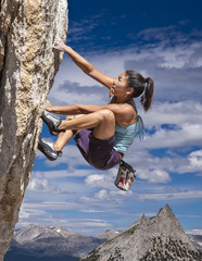 Rock climber clinging to a cliff.