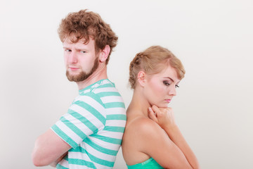 Young couple after quarrel offended back to back