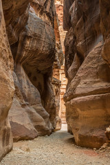 Hiking through the canyon in the ancient city of Petra (Jordan) - opening view of the famous Al-Khazneh (aka Treasury)