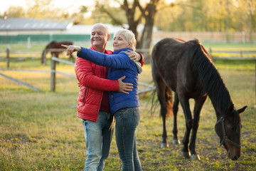 happy seniors couple embrace and smile;