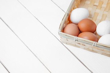 Brown and white eggs on a rustic wooden plank