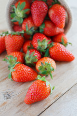 strawberries in small sack on wooden table background