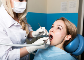 The reception was at the female dentist. Doctor examines the oral cavity on tooth decay. Caries...