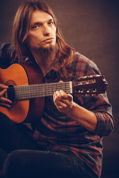 Focused hippie with his guitar.