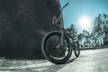 Bmx bike standing against black  wall