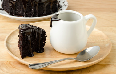 Piece of chocolate cake with chocolate sauce for pouring on top