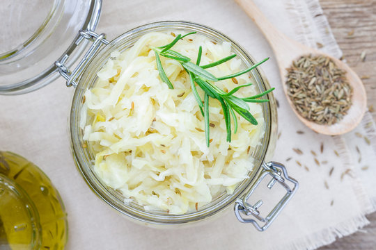 Homemade sauerkraut with cumin in a glass jar, top view
