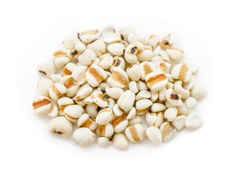 Raw millet rice in wooden spoon on white background.