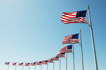 Fototapeta premium USA flags in a row waving in the wind