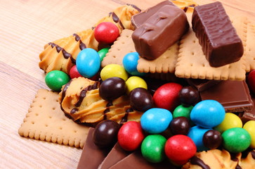 A lot of sweets on wooden surface, unhealthy food