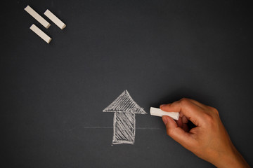 Hand with chalk on board