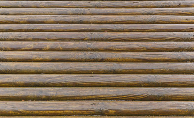 Wall of wooden logs