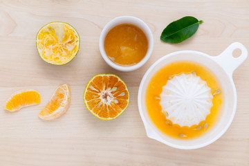 Freshly orange juice with orange slice set up on wooden table .