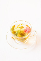 Cup of fresh herbal tea on a white table