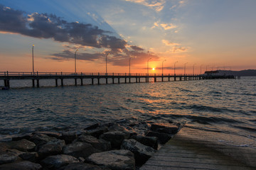 Fototapeta premium Beautiful Sunset with long Jetty in horrizon