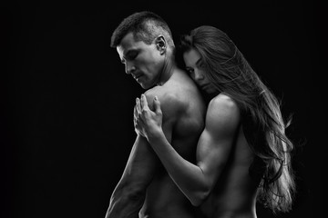 Fototapeta na wymiar Nude sexy couple. Art photo of young adult man and woman. High contrast black and white muscular naked body