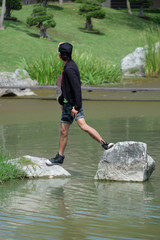 Man standing on rock in the pool water