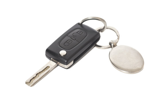Remote control car key with metal keyring on isolated white back