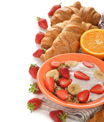 Muesli with yogurt, croissant and fresh strawberries