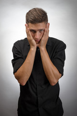 Frustrated businessman holding head in his hands