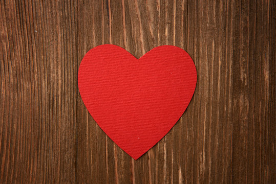 red heart on wooden background
