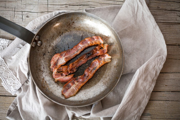 Close-up of bacon slices on frying pan