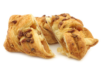 freshly baked pecan buns with apricot filling on a white background