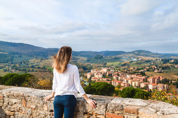 Fototapeta na wymiar Young girl enjoying the view from San Gimignano, Tuscany, Italy