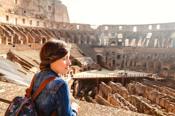 Young girl with backpack exploring inside the Colosseum (Coliseum)