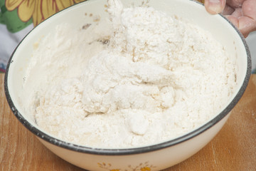 Women's hands preparing fresh yeast dough