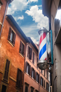 Barber's pole on a narrow cozy street of Rome. Italy