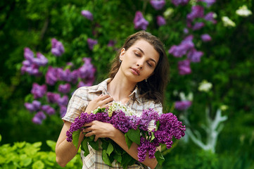 Beautiful girl with a lilac flowers