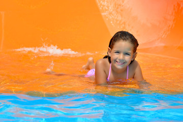 Adorable toddler girl enjoying her summer vacation at aquapark