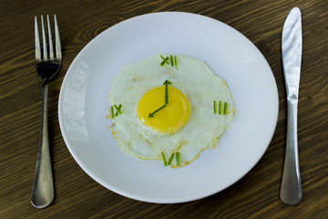 Fried egg in form of a clock