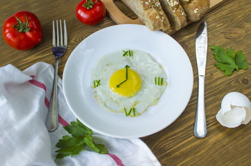 Fried egg in form of a clock