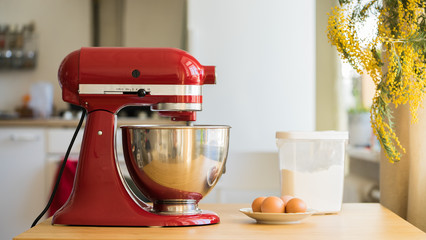 red stand mixer mixing cream