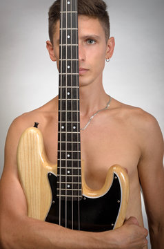 naked man with bass guitar conceptual photo